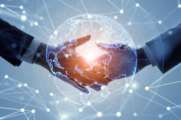 電子契約を象徴する、握手とデジタルグローブ